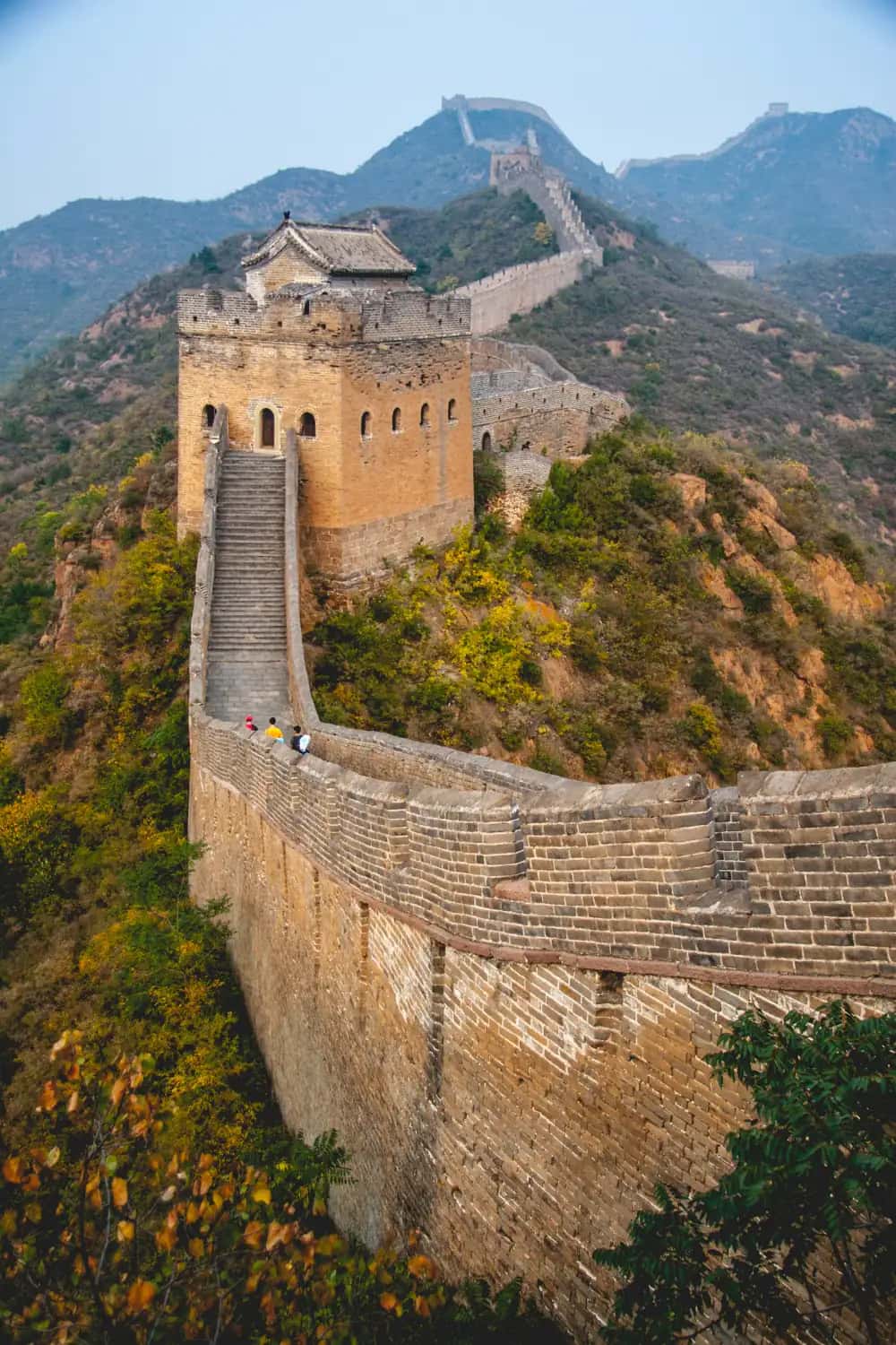 The Great Wall of China winding across green mountain ridges near Beijing